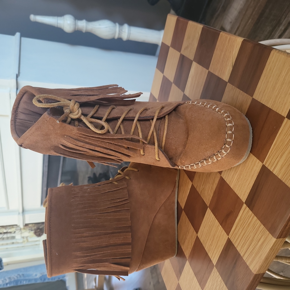 Moccasin fringe ankle booties.